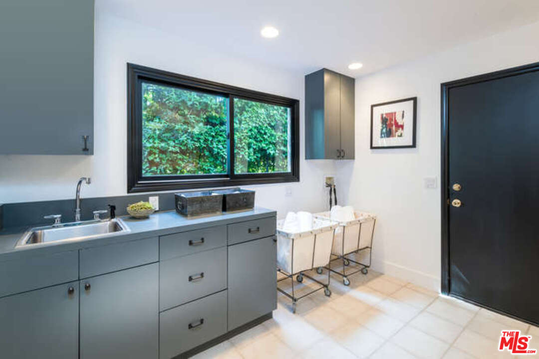 1374 Stradella Road Los Angeles, CA 90077 - Photo 38 of 47 a spacious bathroom with a double vanity sink and a window