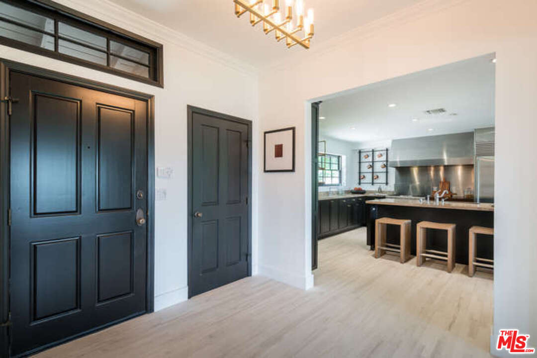 1374 Stradella Road Los Angeles, CA 90077 - Photo 39 of 47 a living room with stainless steel appliances kitchen island furniture and wooden floor