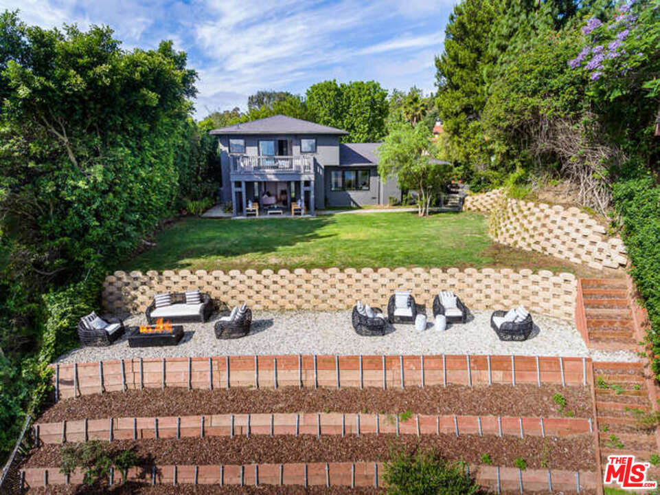 1374 Stradella Road Los Angeles, CA 90077 - Photo 5 of 47 a front view of a house with a yard