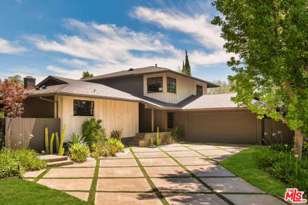 1374 Stradella Road Los Angeles, CA 90077 - Photo 47 of 47 a front view of a house with a yard and potted plants