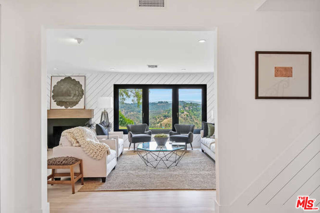 1374 Stradella Road Los Angeles, CA 90077 - Photo 7 of 47 a living room with furniture and a large window