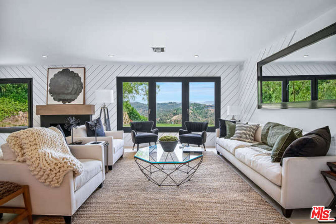1374 Stradella Road Los Angeles, CA 90077 - Photo 8 of 47 a living room with furniture and a large window