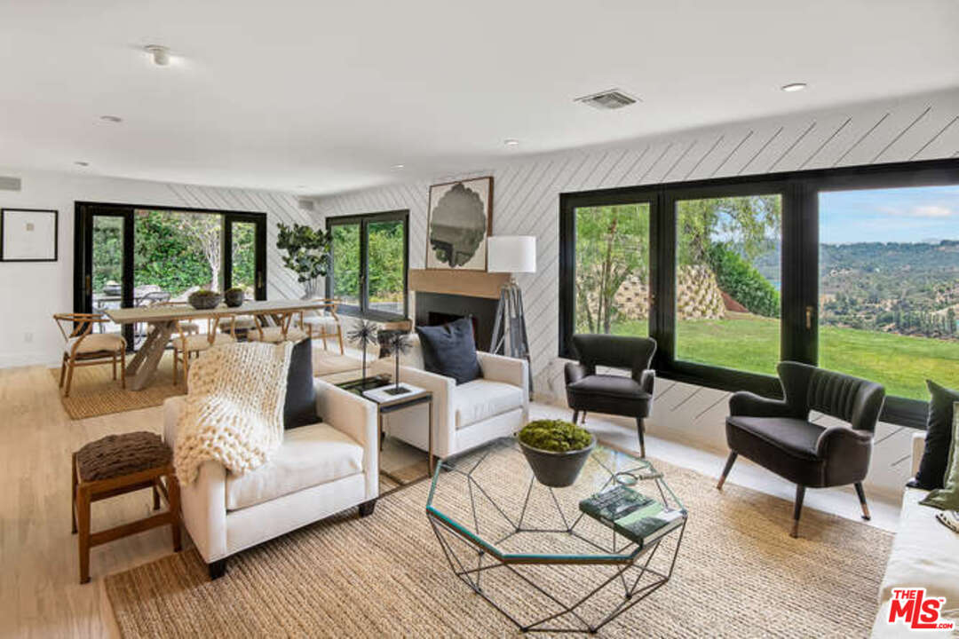 1374 Stradella Road Los Angeles, CA 90077 - Photo 9 of 47 a living room with furniture and a fireplace