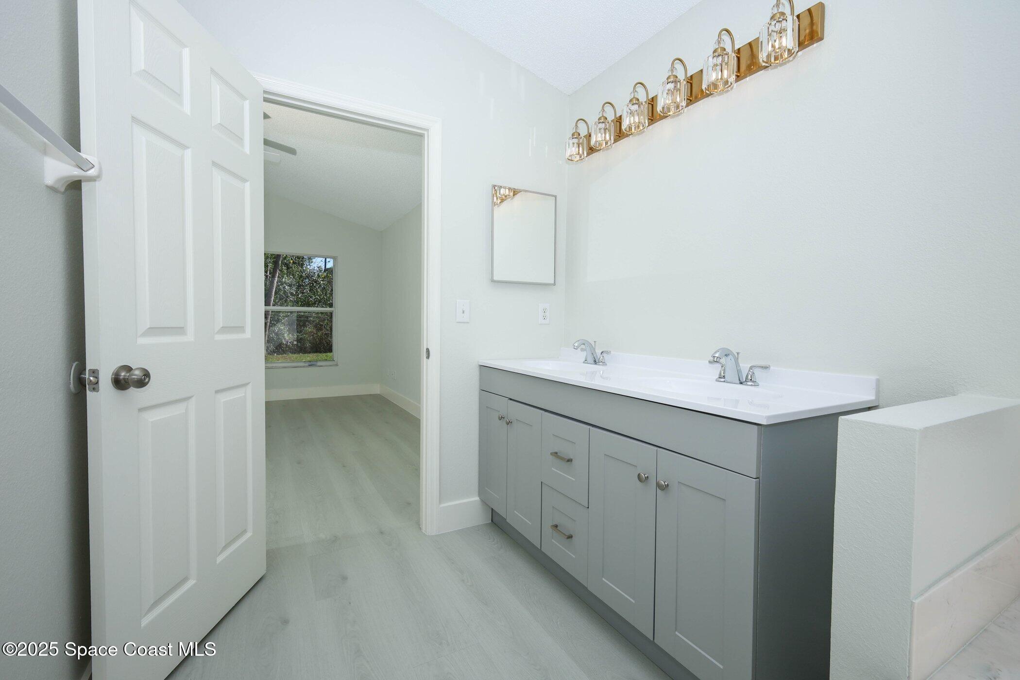 3700 Becontree Place Oviedo, FL 32765 - Photo 16 of 39 a spacious bathroom with a double vanity sink a mirror and shower