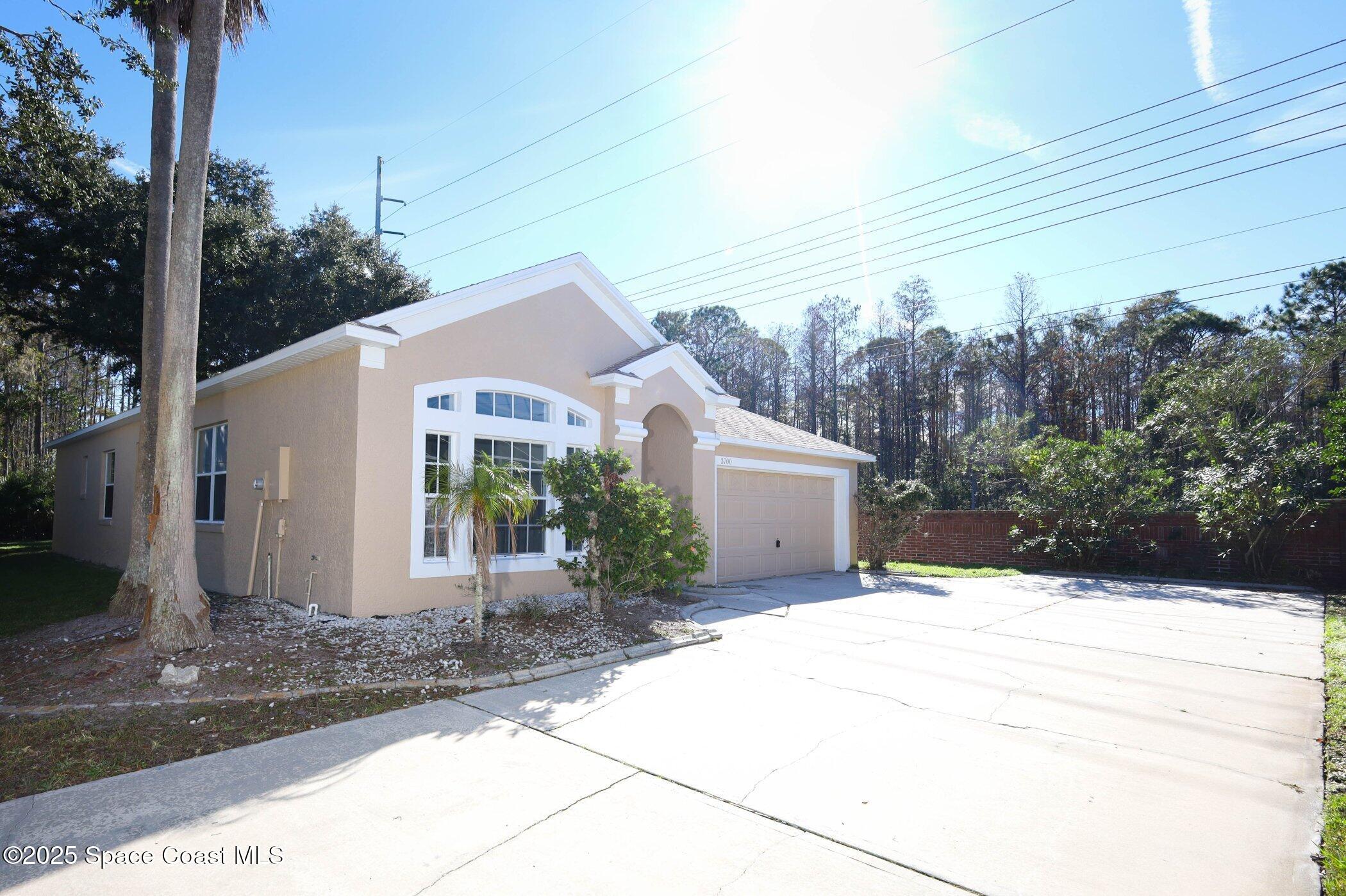 3700 Becontree Place Oviedo, FL 32765 - Photo 2 of 39 a view of a white house with a yard and potted plants