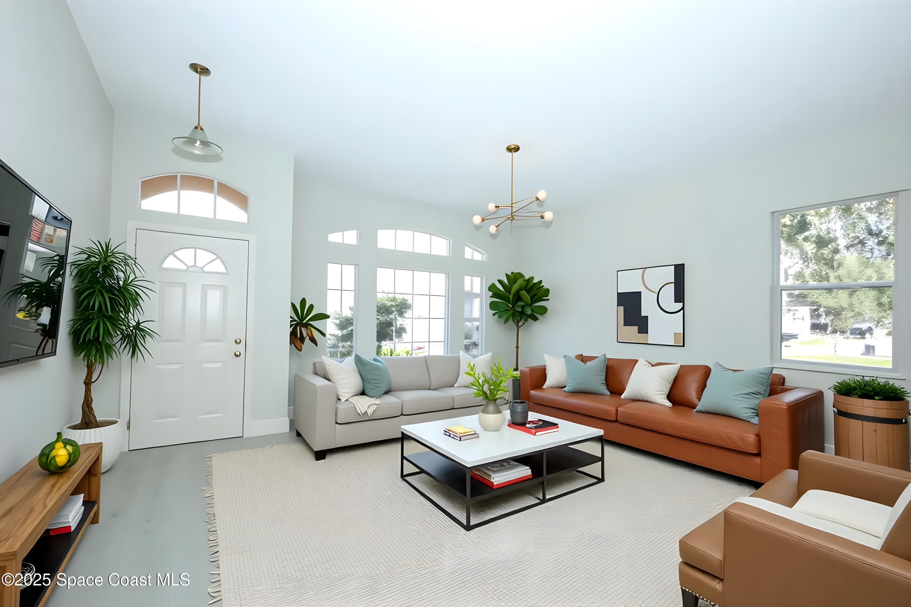 3700 Becontree Place Oviedo, FL 32765 - Photo 3 of 39 a living room with furniture and a chandelier