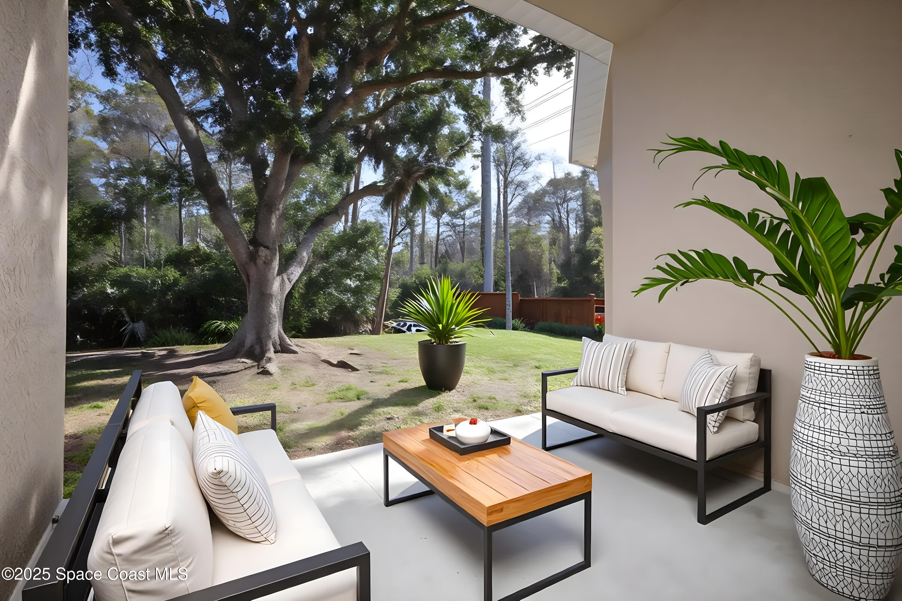 3700 Becontree Place Oviedo, FL 32765 - Photo 34 of 39 a view of a patio with couches and a potted plant on a table