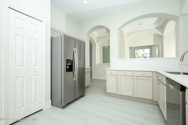 a spacious bathroom with a granite countertop sink and a mirror