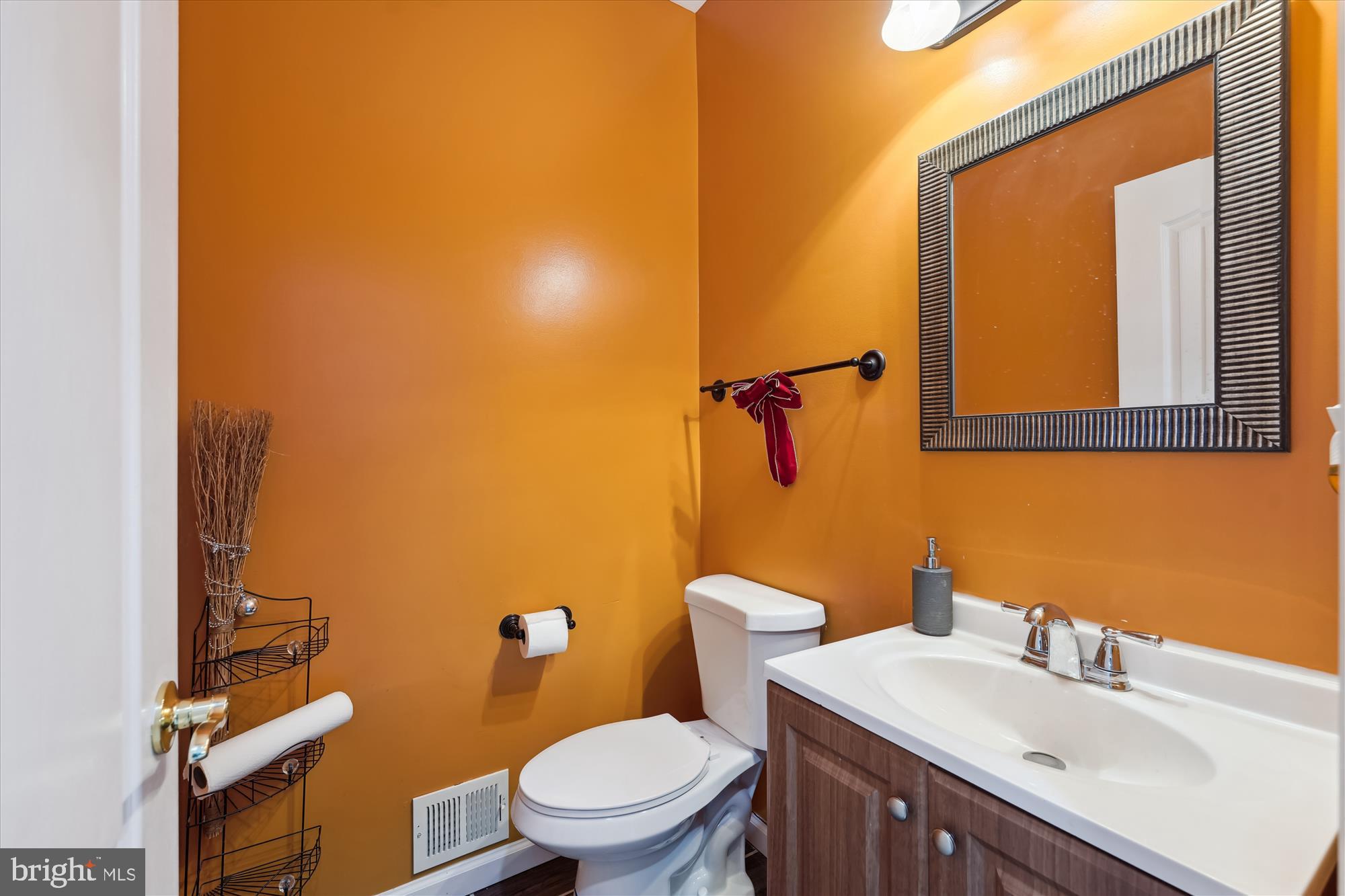 7306 Sudley Avenue Brandywine, MD 20613 - Photo 22 of 46 a bathroom with a sink mirror vanity and toilet