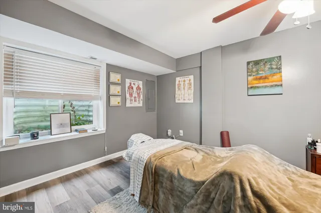 a bedroom with a bed and a large window