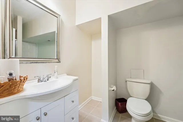 a bathroom with a toilet a sink and a mirror