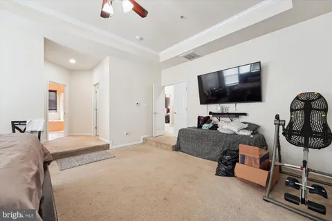 a bedroom with furniture and a flat screen tv