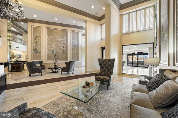 a living room with furniture windows and a table