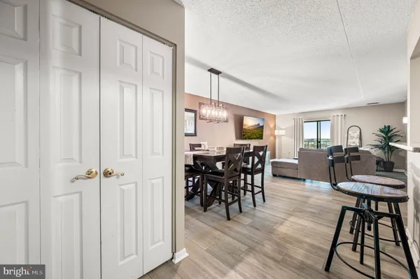 a view of a dining room with furniture and chandelier