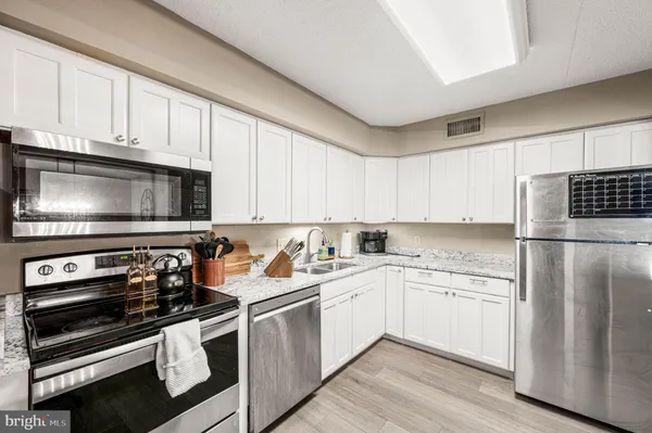 a view of a workspace with furniture and wooden floor