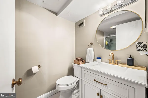 a bathroom with a glass shower door mirror and a shower