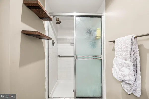 a bedroom with a bed wooden floor and a television