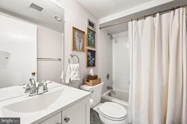 a view of a livingroom with a flat screen tv wooden floor and a window