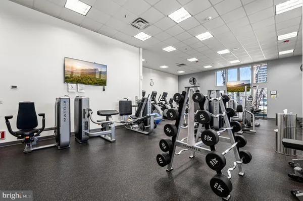 a living room with lots of furniture and kitchen view
