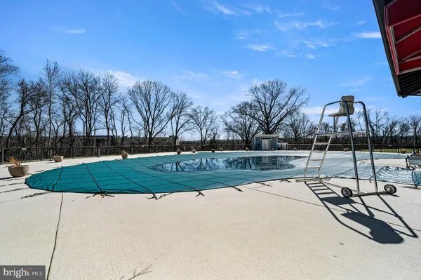 aerial view of a house with swimming pool and porch