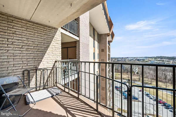 a view of a balcony with wooden floor and fence