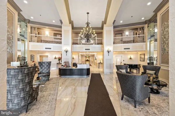 a living room with fireplace furniture and a large window