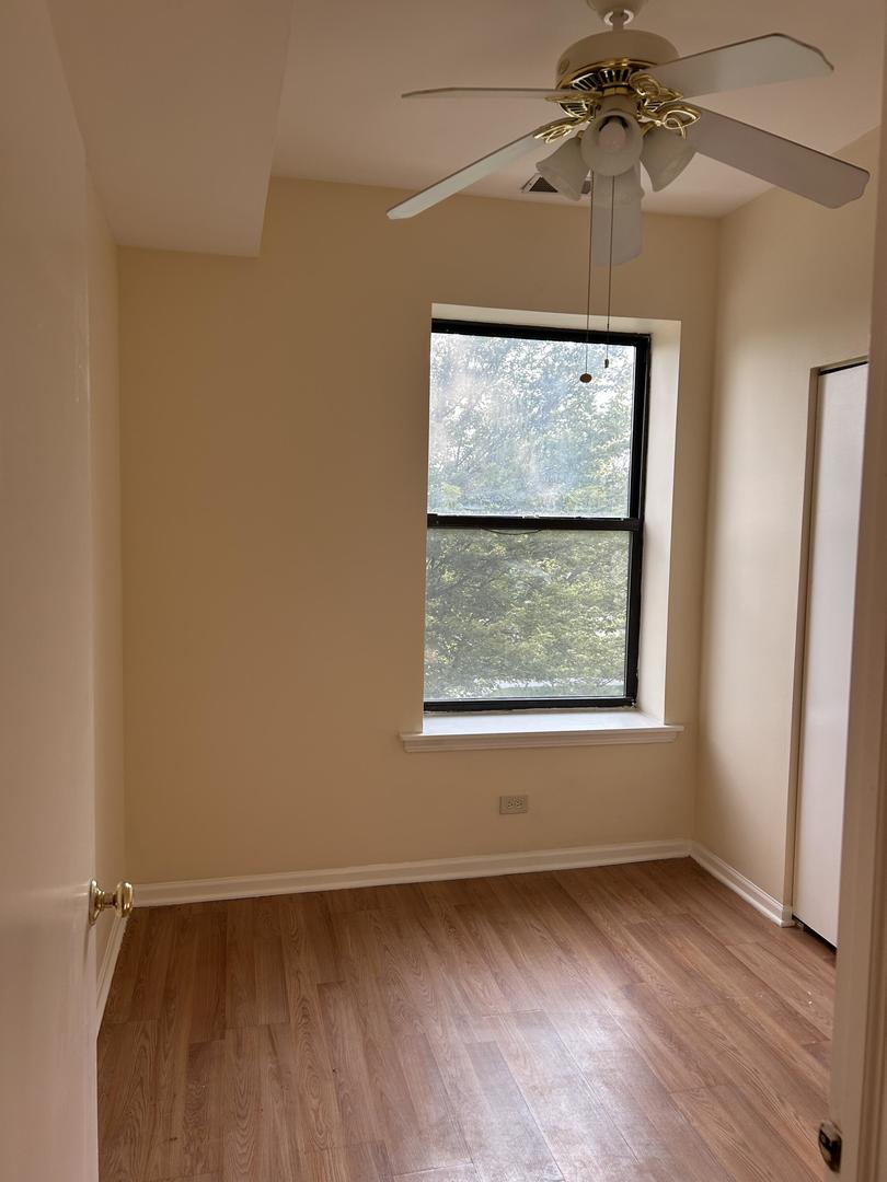 800 South Independence Boulevard, Unit 3 Chicago, IL 60624 - Photo 2 of 12 an empty room with a window and a ceiling fan