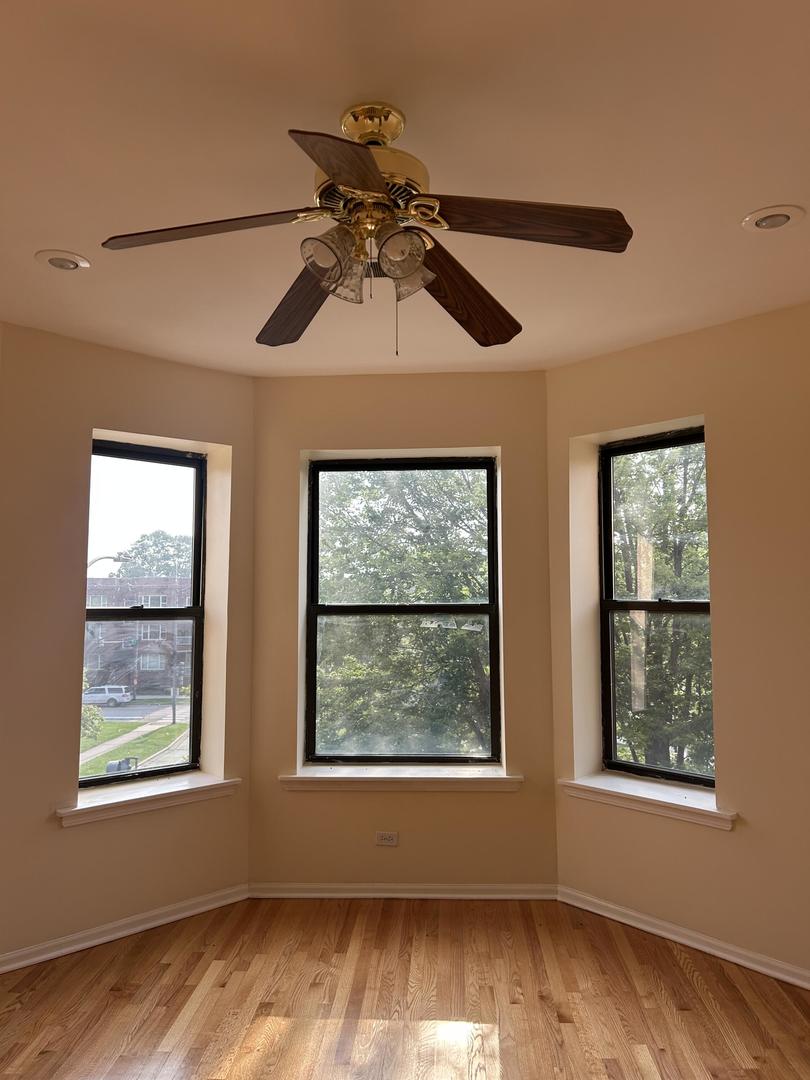 800 South Independence Boulevard, Unit 3 Chicago, IL 60624 - Photo 3 of 12 a view of an empty room with wooden floor and a window