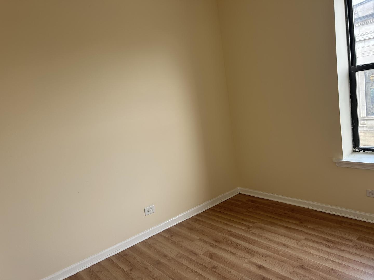 800 South Independence Boulevard, Unit 3 Chicago, IL 60624 - Photo 5 of 12 a view of a small space with wooden floor and a window