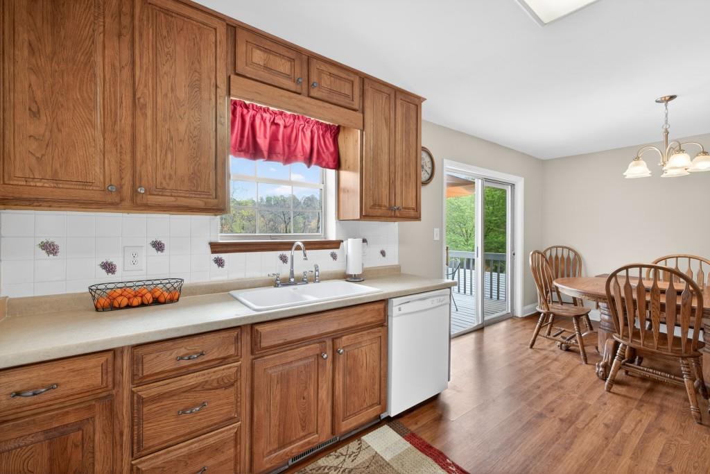 335 Ranger Way Braselton, GA 30517 - Photo 11 of 63 a kitchen with granite countertop sink table and chairs