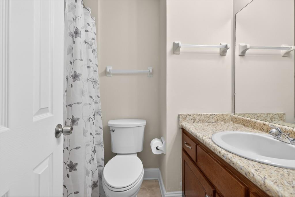 335 Ranger Way Braselton, GA 30517 - Photo 13 of 63 a bathroom with a granite countertop toilet sink and mirror
