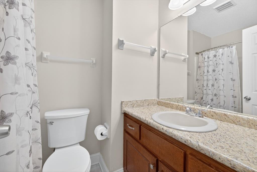 335 Ranger Way Braselton, GA 30517 - Photo 14 of 63 a bathroom with a granite countertop sink toilet and shower