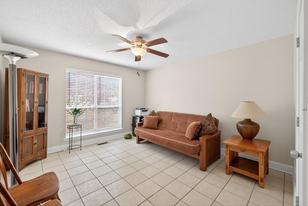 335 Ranger Way Braselton, GA 30517 - Photo 15 of 63 a living room with furniture a ceiling fan and a window