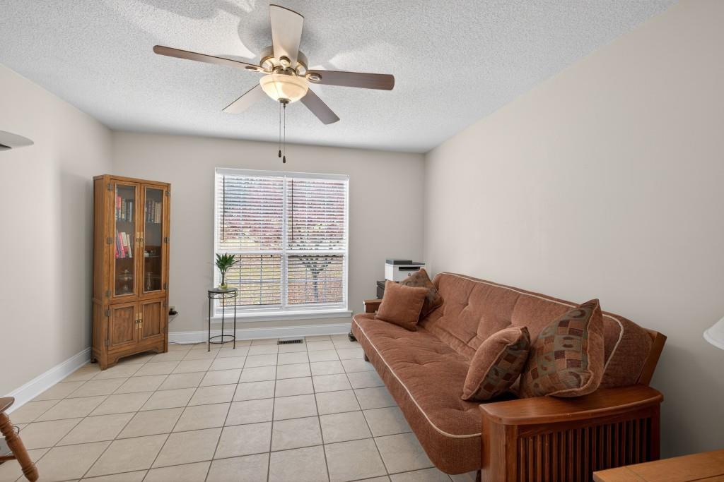 335 Ranger Way Braselton, GA 30517 - Photo 17 of 63 a living room with furniture and a floor to ceiling window