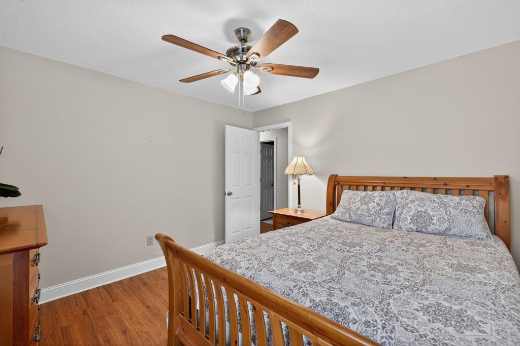 335 Ranger Way Braselton, GA 30517 - Photo 19 of 63 a bedroom with a large bed and a chandelier