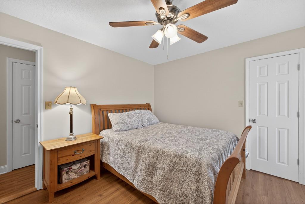 335 Ranger Way Braselton, GA 30517 - Photo 20 of 63 a bedroom with a bed and a chandelier