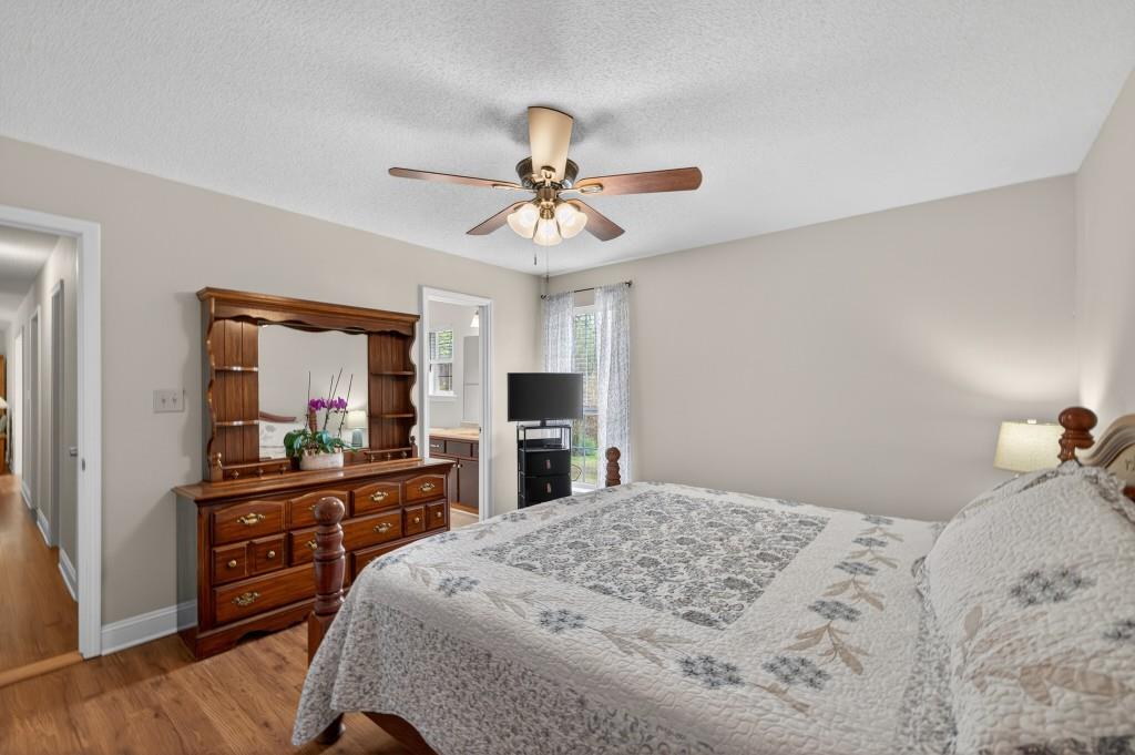 335 Ranger Way Braselton, GA 30517 - Photo 22 of 63 a bedroom with a bed and a flat tv screen on dresser