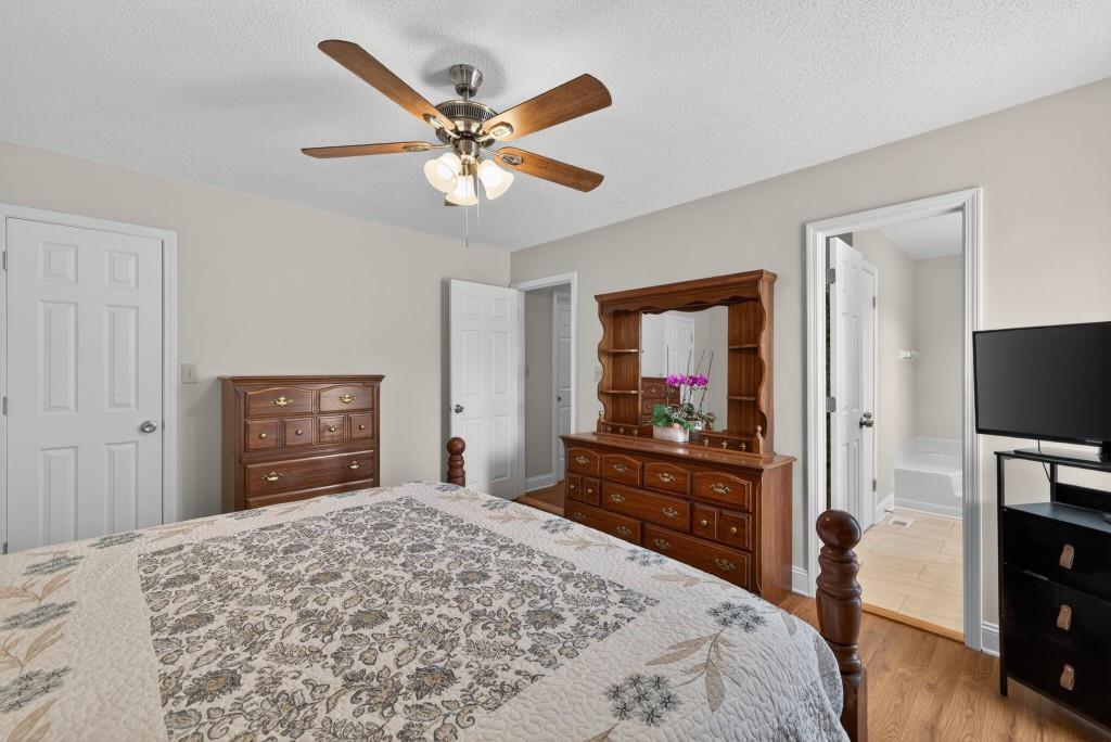 335 Ranger Way Braselton, GA 30517 - Photo 23 of 63 a bedroom with a bed and a flat screen tv