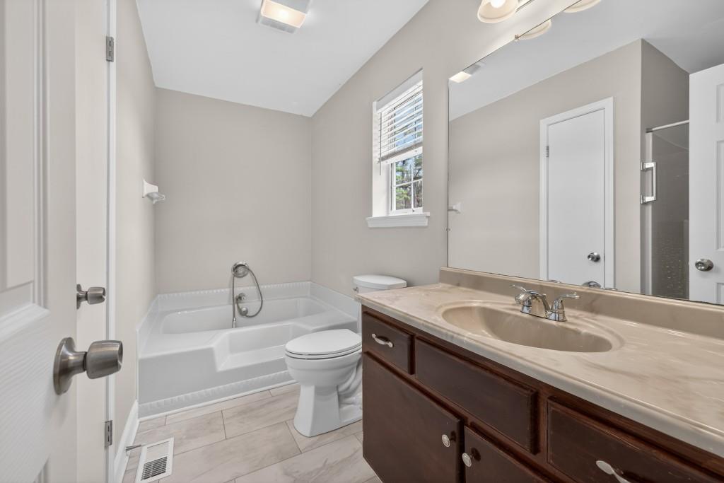 335 Ranger Way Braselton, GA 30517 - Photo 26 of 63 a bathroom with a sink and a mirror