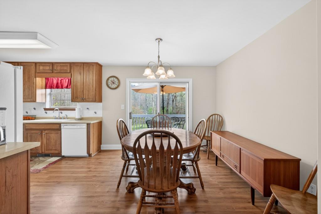 335 Ranger Way Braselton, GA 30517 - Photo 6 of 63 a dining room with furniture a chandelier and wooden floor