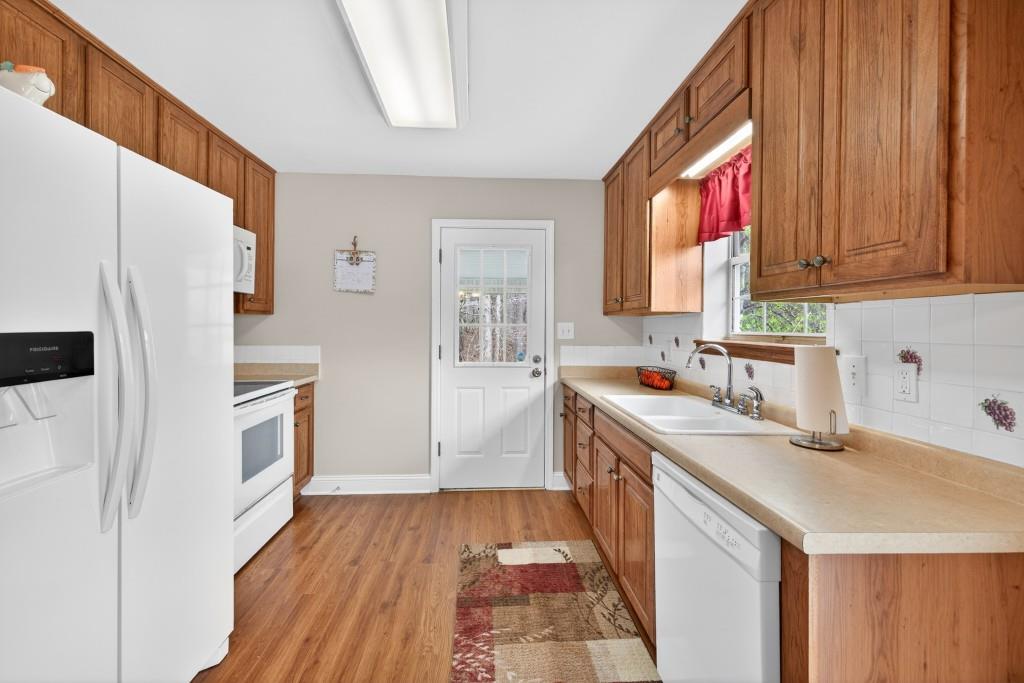 335 Ranger Way Braselton, GA 30517 - Photo 10 of 63 a kitchen with a sink a refrigerator a stove and a window