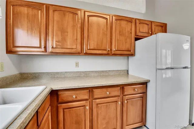 a view of an empty room with a window and dresser