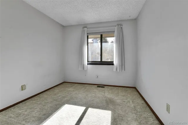 a view of an empty room with wooden walls