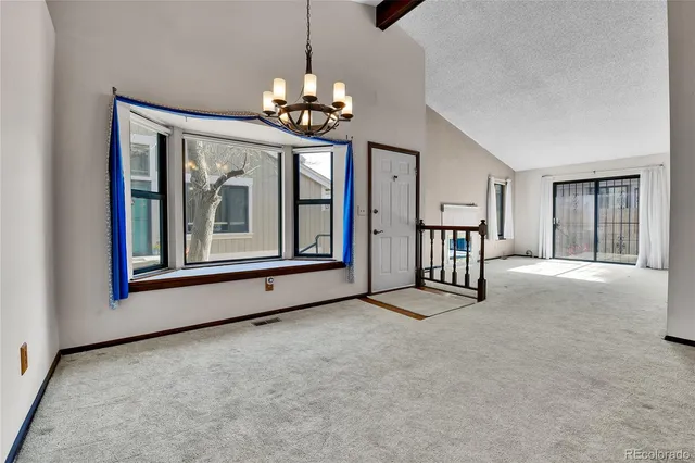 a view of a livingroom with a furniture and staircase