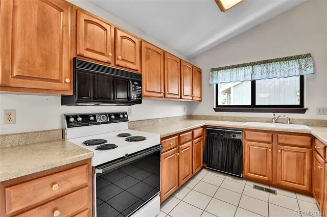 a kitchen with stainless steel appliances granite countertop a refrigerator and cabinets