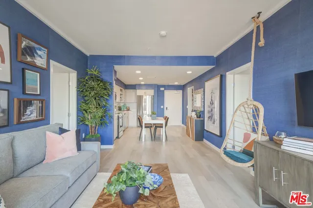 a living room with furniture and a floor to ceiling window