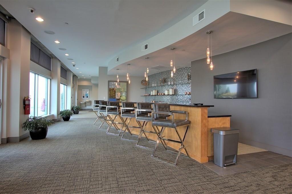 250 Pharr Road Northeast, Unit 601 Atlanta, GA 30305 - Photo 30 of 34 a lobby with furniture and a flat screen tv