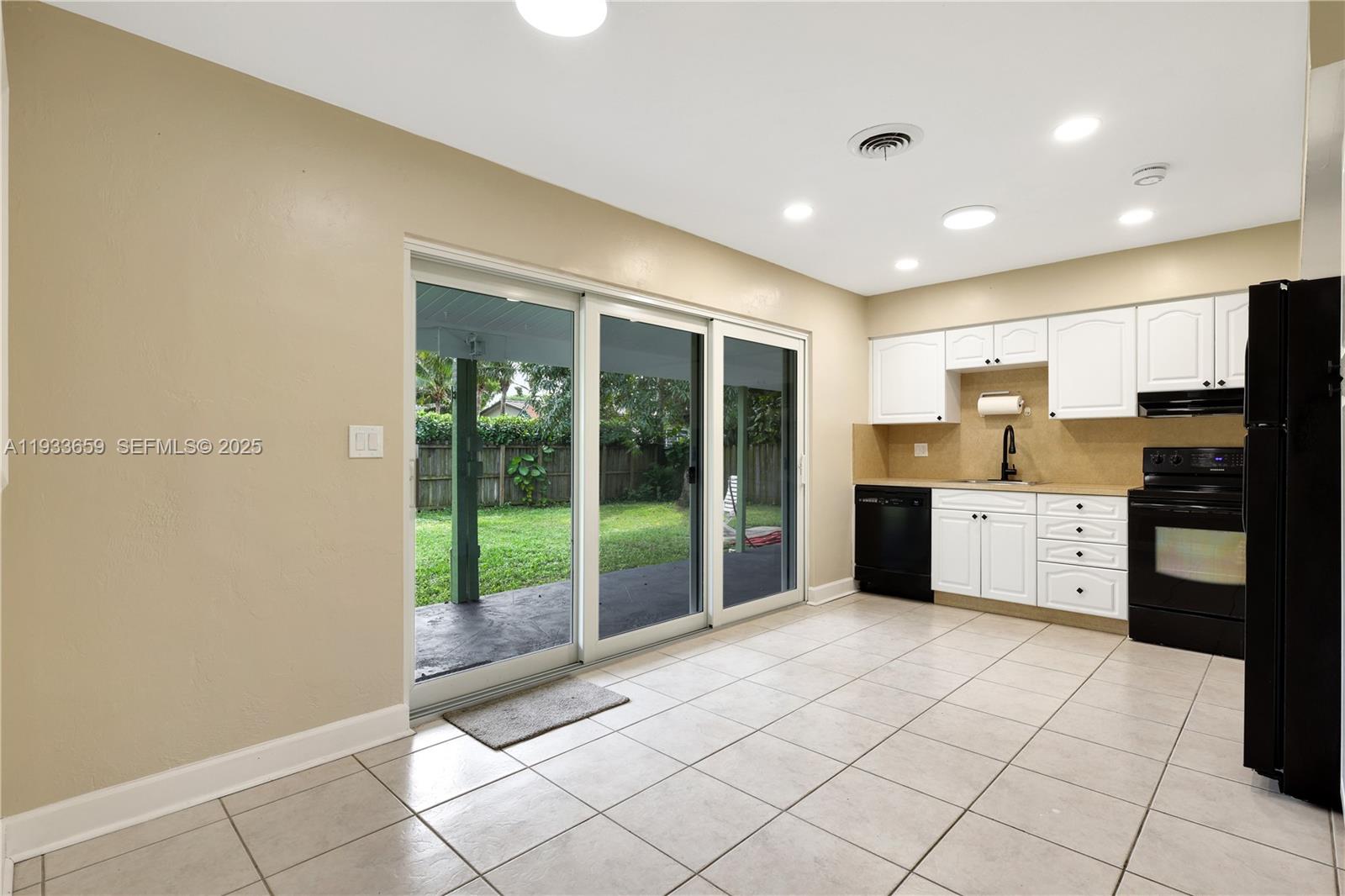 142 Southwest 53rd Avenue Plantation, FL 33317 - Photo 13 of 30 a kitchen with stainless steel appliances granite countertop a refrigerator and a sink