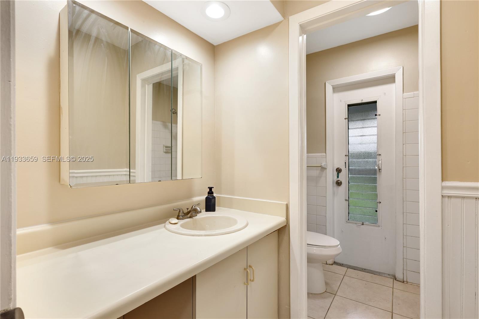 142 Southwest 53rd Avenue Plantation, FL 33317 - Photo 17 of 30 a bathroom with a sink and a mirror