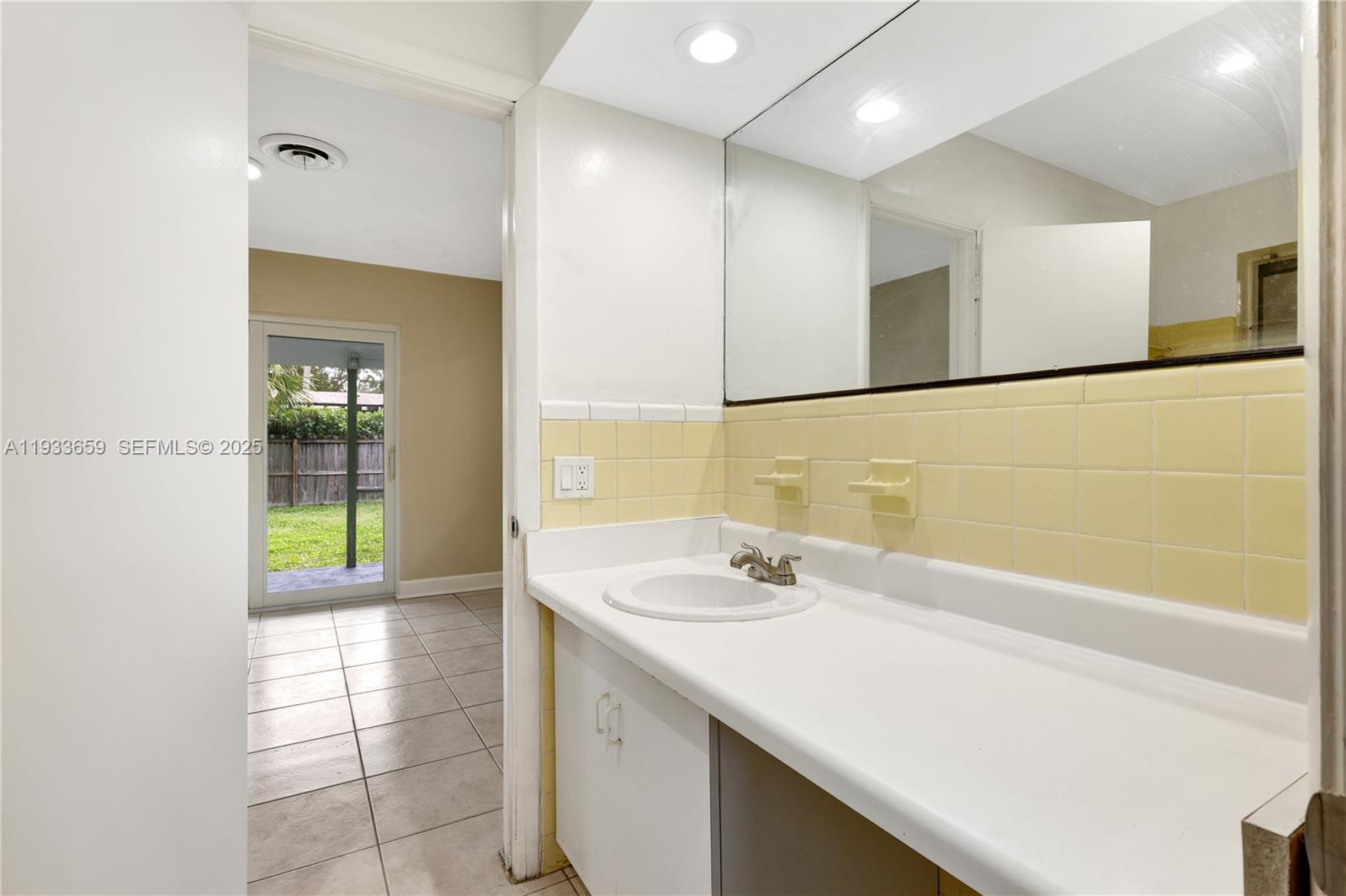 142 Southwest 53rd Avenue Plantation, FL 33317 - Photo 19 of 30 a bathroom with a sink and a mirror